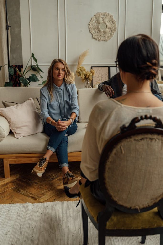 A therapist and client in discussion during a cozy indoor session highlighting mental health.